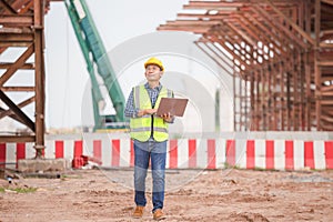 Engineer man with laptop at construction site, Foreman worker checking project in building site