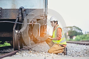 Engineer man sitting on railway inspection. construction worker on railways. Engineer work using tablet to report of Train