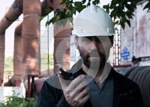 Engineer man supervisor holding blueprints plan and inspects the pipeline