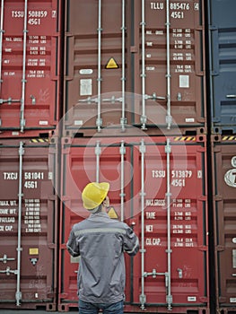 Engineer man wearing safety helmet standing front of container