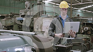 Engineer man working on laptop computer for inspector and maintenance equipment at factory.