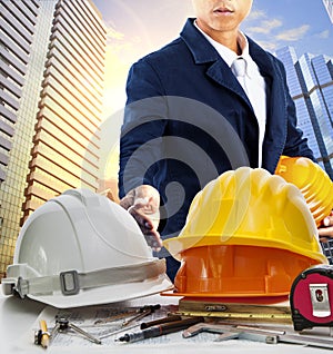 engineer man and working table against sky scrapper in urban scene use for land development and architecture occupation theme