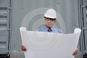 Engineer manager look at consturction paper plan