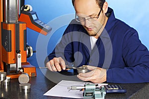 Engineer measuring with caliper photo