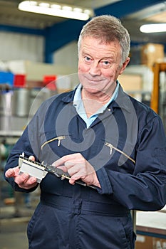 Engineer Measuring Component With Micrometer