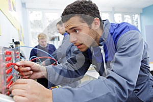 engineer measuring multimeter panel board