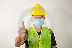 Engineer in medical mask touching transparent screen display with selectived focus on finger.
