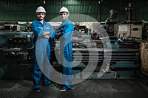 Engineer men wearing uniform safety workers perform maintenance in factory working machine.