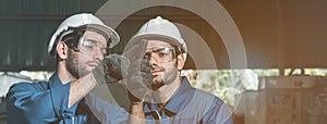 Engineer men wearing uniform safety workers perform maintenance in factory working machine lathe metal