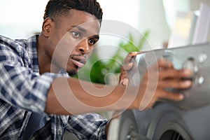 engineer mending domestic washing machine