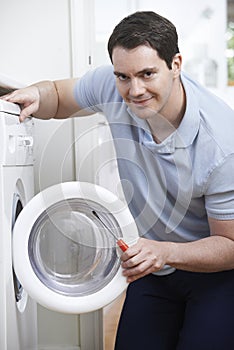 Engineer Mending Domestic Washing Machine photo