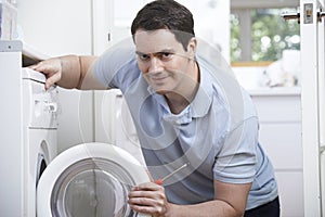 Engineer Mending Domestic Washing Machine photo