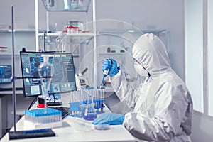 Engineer in microbiology lab holding micropipette