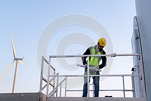 Engineer at natural energy wind turbine site with a mission to climb up to the wind turbine blades