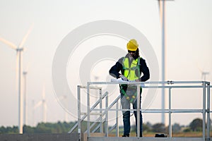 Engineer at natural energy wind turbine site with a mission to climb up to the wind turbine blades