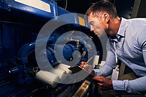 Engineer performing visual inspection of generating unit