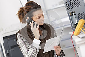 Engineer on phone working with circuits