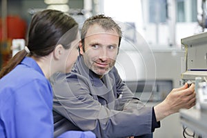 engineer planning project with cnc machinery in background