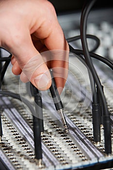 Engineer Plugging Cable Into Patch Panel