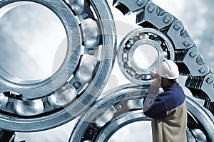 Engineer pointing at ball-bearings and chains