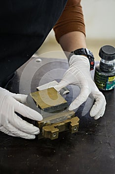 Engineer preparing a soil sample in a mold for direct shear laboratory test