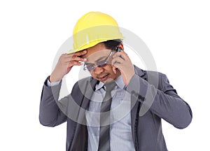 Engineer receiving bad news on the cell phone isolated on white