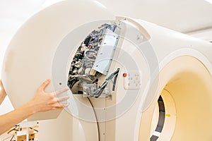 engineer removes cover of a computer tomograph.