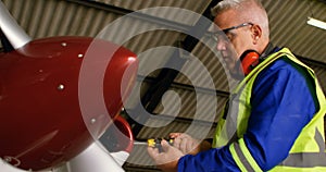 Engineer repairing aircraft at aerospace hangar 4k