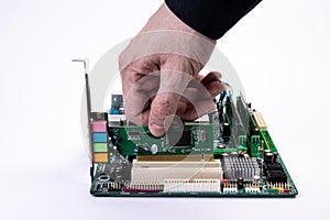 Engineer repairman holding hands in black gloves chip processor, CPU to insert into the socket of the computer motherboard. The