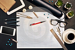 Engineer`s desk in office with various gadgets and documents