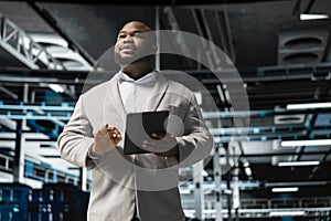Engineer in server room overseeing mainframes gear