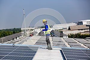 Engineer service check installation solar cell on the roof of factory.