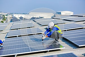 Engineer service check installation solar cell on the roof of factory.