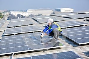 Engineer service check installation solar cell on the roof of factory.