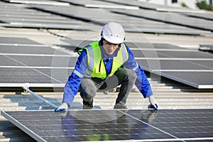 Engineer service check installation solar cell on the roof of factory.