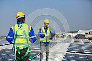 Engineer service check installation solar cell on the roof of factory.