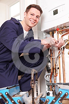 Engineer Servicing Central Heating Boiler