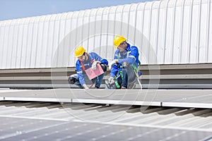 Engineer set installing and inspect standards of solar panels on roof of an industrial factory. Team technician inspection and