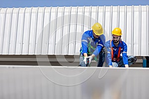Engineer set installing and inspect standards of solar panels on roof of an industrial factory. Team technician inspection and