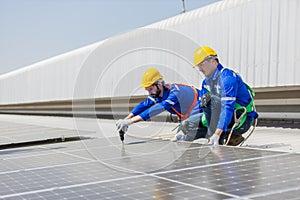 Engineer set installing and inspect standards of solar panels on roof of an industrial factory. Team technician inspection and