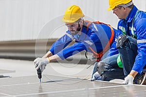 Engineer set installing and inspect standards of solar panels on roof of an industrial factory. Team technician inspection and