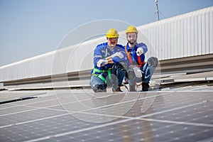 Engineer set installing and inspect standards of solar panels on roof of an industrial factory. Team technician inspection and