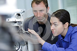 engineer showing equipment to female apprentice