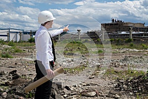 Engineer on site pointing old building