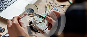 IT engineer solder microchip with soldering iron