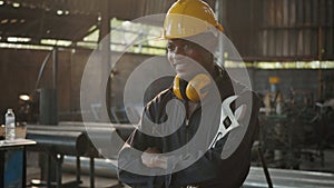 Engineer standing holding wrench tools and arms crossed at work in the industry