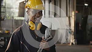 Engineer standing holding wrench tools and arms crossed at work in the industry