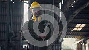 Engineer standing holding wrench tools and arms crossed at work in the industry