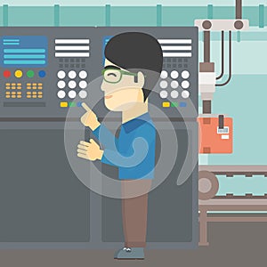 Engineer standing near control panel.