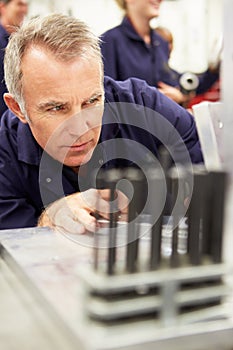 Engineer Studying Component In Workshop photo